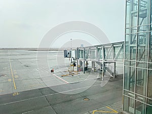 Transparent corridor for passengers to board the plane and telescopic gangway. Parking for the plane at the airport. Mobile