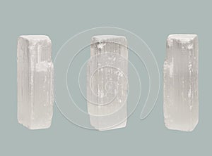 Transparent crystal of Selenite isolated on blue background photo