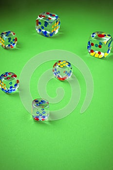 Transparent cubes for casino/transparent cubes for casino are scattered on green cloth. Top view
