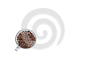 Transparent cup full of roasted coffee beans on a white background