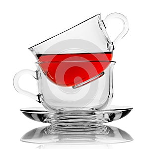 Transparent cups with tea on a white background