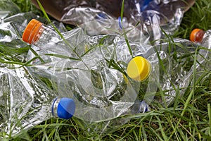 transparent empty water bottles are gathered in the paper bag