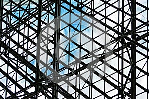 Transparent futuristic glass roof with metal construction of the ceiling. Modern urban architecture