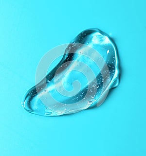 Transparent gel drop. Liquid cream gel cosmetic smudge texture on blue or green background