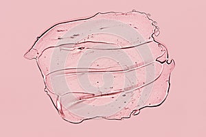 Transparent gel spot on pink background. Textured smear with oxygen bubbles