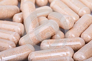 Transparent gelatine capsules with powder, close up view.