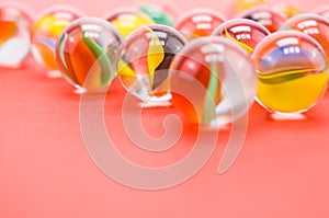 Transparent glass balls on a pink background