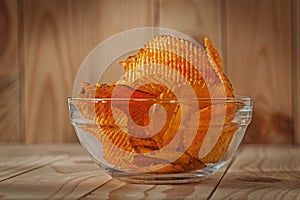 Transparent Glass Bowl Of Potato Chips With Paprika