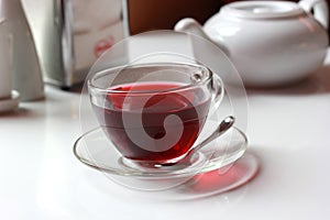 Transparent glass cup of red fruit tea on the