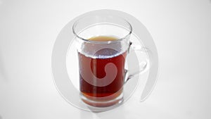 Transparent glass Cup with tea isolated on white.