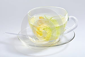 Transparent glass cup of tea with linden isolated