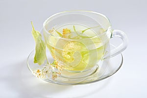 Transparent glass cup of tea with linden isolated