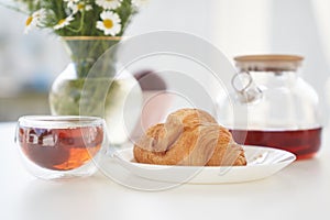 Transparent glass Cup of tea in nature. The concept of breakfast in the backyard of the house. Early morning, tea and