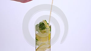 Transparent glass with a drink. make lemonade with lemon slices