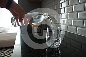 Transparent glass with drinking water on the kitchen table