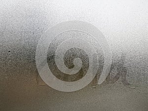 Transparent glass with fog up and water drop on it during winter season with Cold hand writing letter on it. Close up shot of