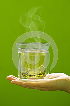 Transparent glass with hot green tea