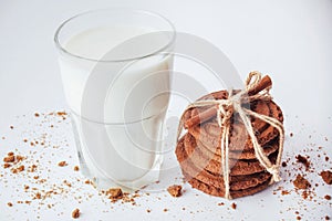 Transparent glass of milk and cookies on a white background