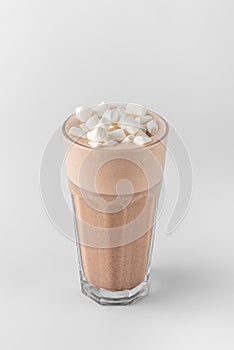 Transparent glass with raf coffee decorated by marshmallow made with espresso, frothed milk, cream, syrup and topping isolated on