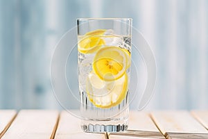 transparent glass of sparkling water with lemon slices