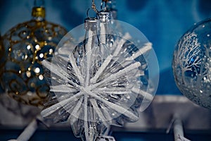 Transparent glass star shaped ornaments with line frosty pattern. Fairytale Christmas tree ornaments closeup.