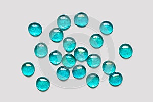 Transparent, glass stones, turquoise color on a light background