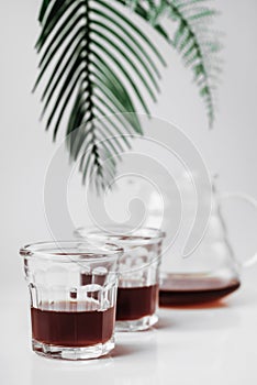 Transparent glass teapot and glasses on white background