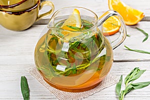 Transparent glass teapot with mango flavored tea