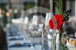 Transparent glass vase with colourful bouquet of flowers against