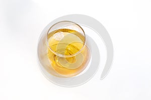 Transparent glass with whiskey top view on white isolated background