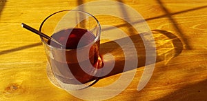 Transparent Glasses with sweet drinks inside with colorful drink, with shadow and table background with ice cubes