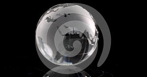 Transparent globe with world map whirling on black background 4k movie