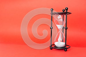 Transparent hourglass, Red background. On the right. Copy, text space