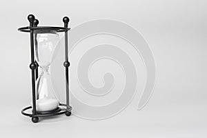 Transparent hourglass, White background. On the left. Copy, text space