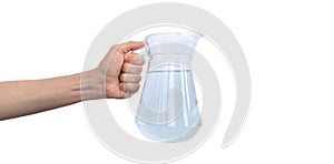 Transparent jar of water, carafe glass in hand isolated on a white background photo