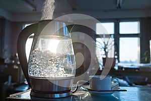 Transparent kettle with water boils