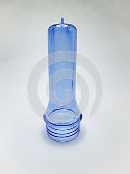 transparent light blue preform isolated on a white background,This polymer is the form before it becomes a plastic bottle