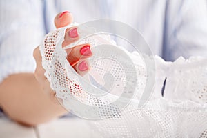 transparent panties on white background in female hands