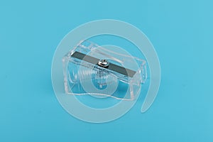 Transparent Pencil Sharpener. Photo of one pencil-sharpener on a blue background