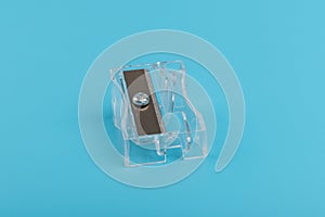 Transparent Pencil Sharpener. Photo of one pencil-sharpener on a blue background