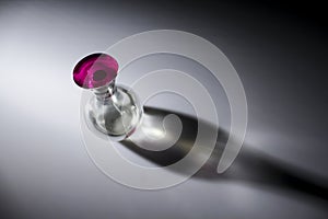 Transparent perfume bottle with pink lid photo