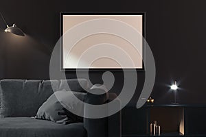 Transparent photo frame with blank poster on dark walls near black couch, 3d rendering. Living room modern interior.