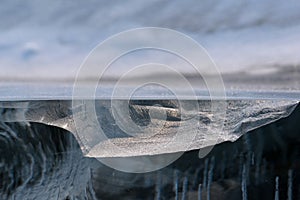 Transparent piece of ice like geological cross-section of Baikal lake