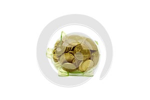 Transparent piggy bank full of coins in studio