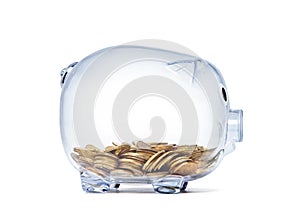 Transparent piggy bank with golden coins on white background