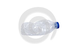 Transparent plastic bottle, blue bottle cap crushed on white background