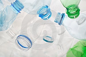 Transparent plastic bottle crumpled plastic recycling waste sorting. Pile of bottles PET recycling bottles background