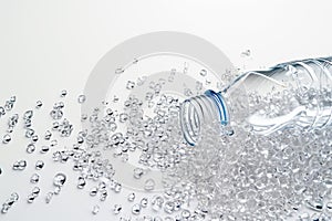 Transparent plastic bottle and PVC granulate background, recycled plastic granules, biodegradable plastic. Granules of