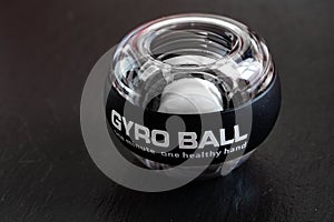 Transparent plastic gyroball on black background