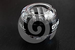 Transparent plastic gyroball on black background